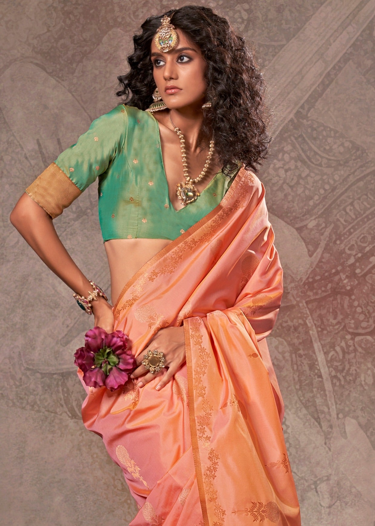 Elegant peach banarasi silk saree with delicate weaving details, complemented by a contrasting green blouse.