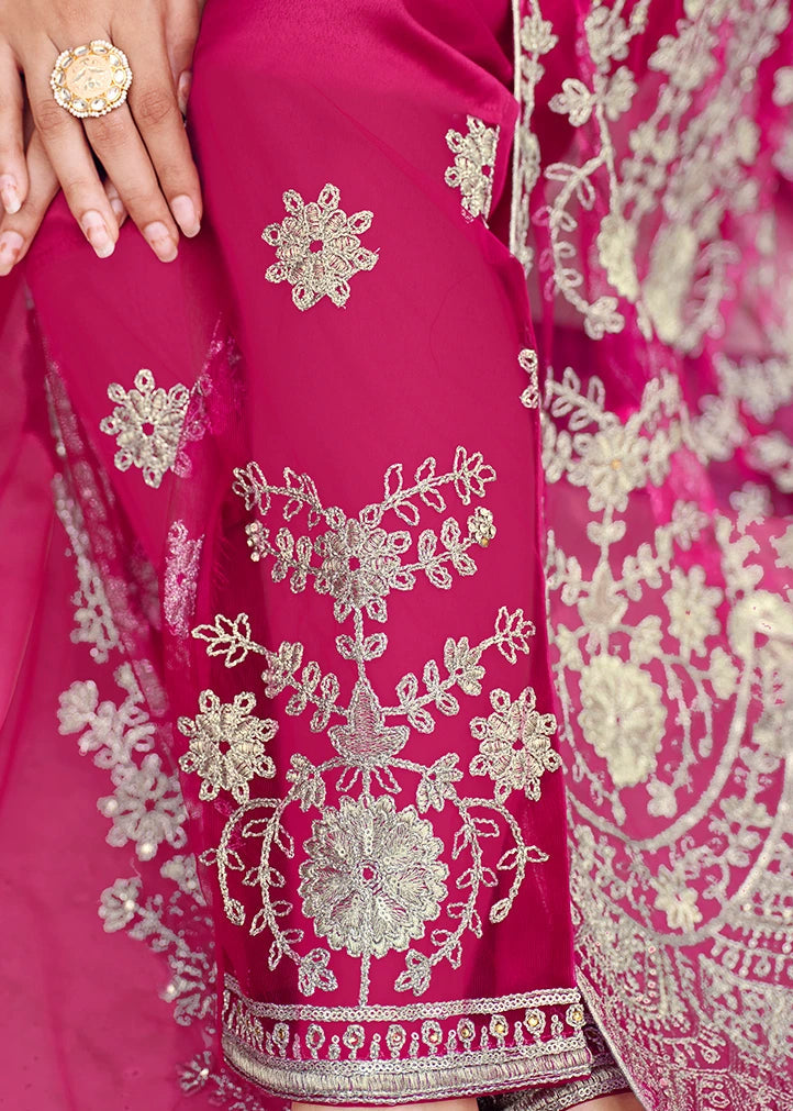 Close-up of matching rani pink silk pant of anarkali with traditional indian gold embroidery available for online sale in new york USA.