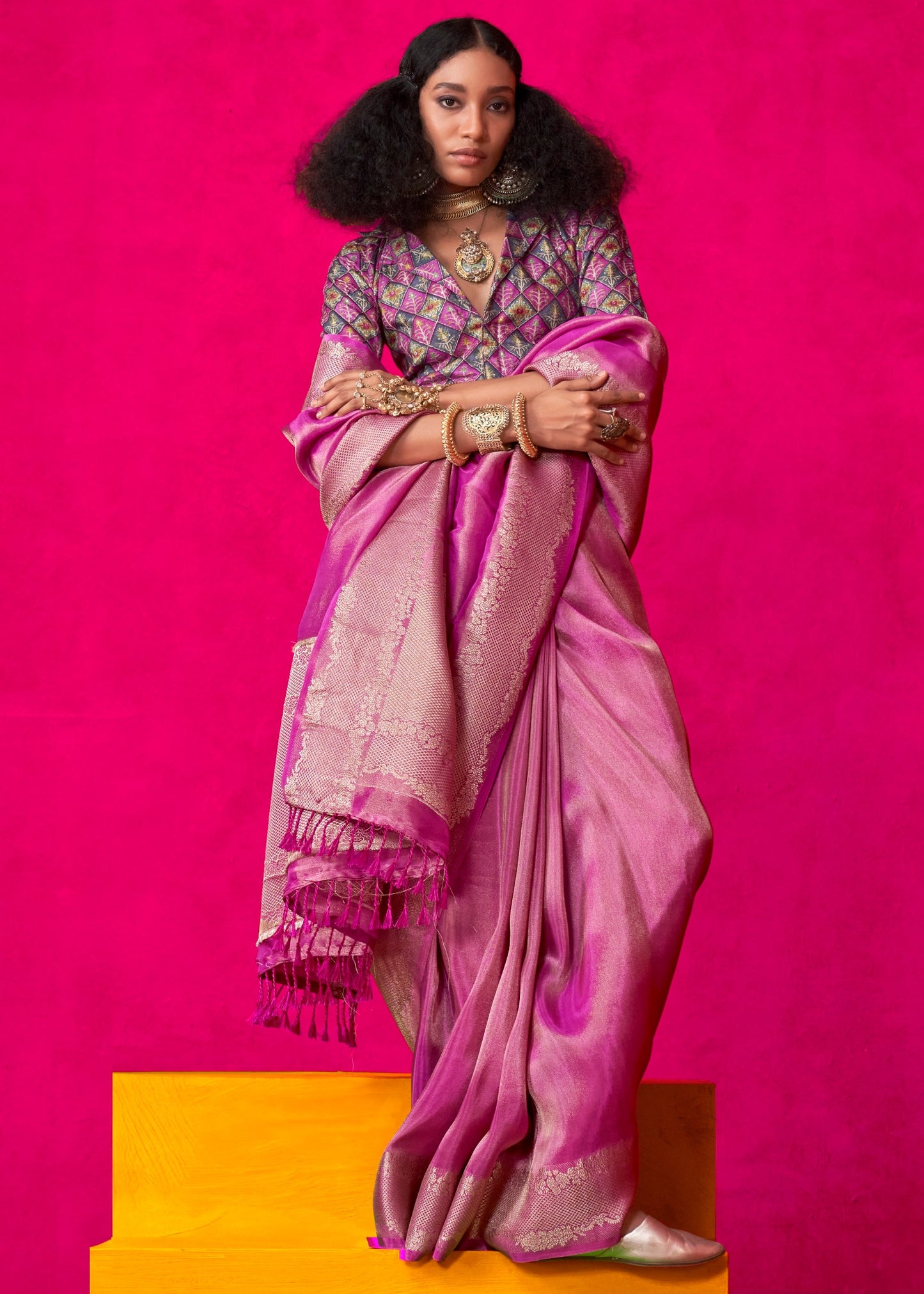 Pink banarasi viscose tissue silk saree draped gracefully, highlighting the exquisite gold zari detailing along the border and pallu.