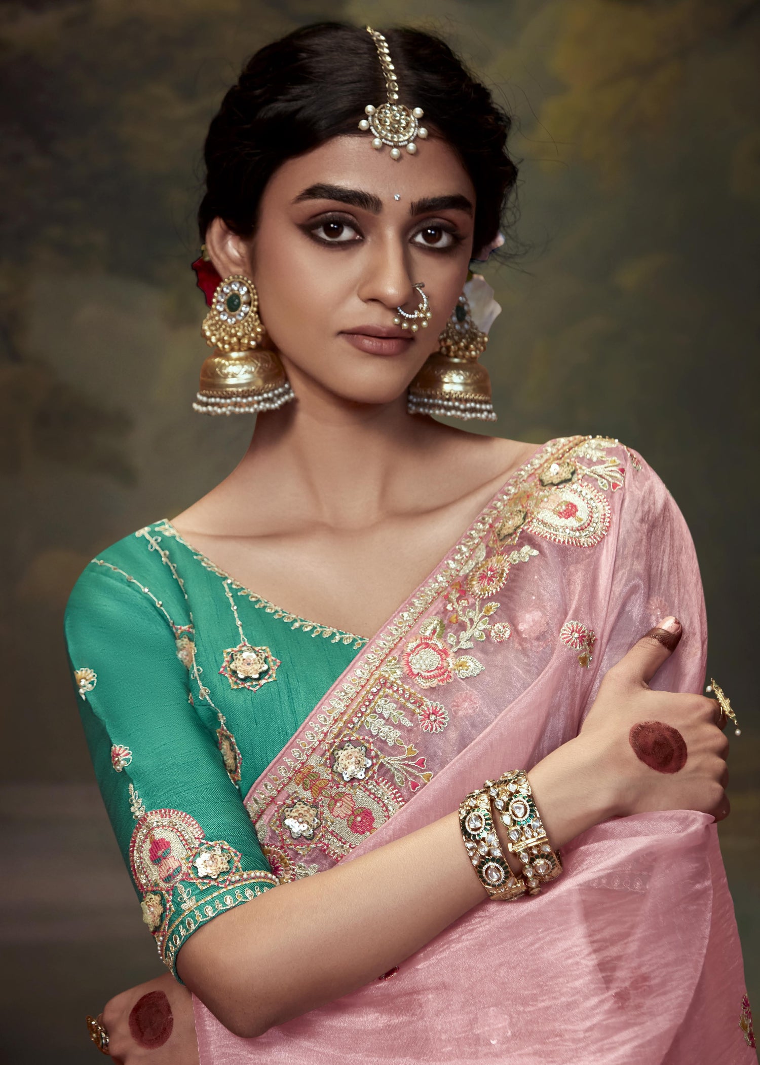 Elegant rose pink tissue silk saree with intricate embroidery and green blouse piece, ideal for wedding and party wear in the USA.