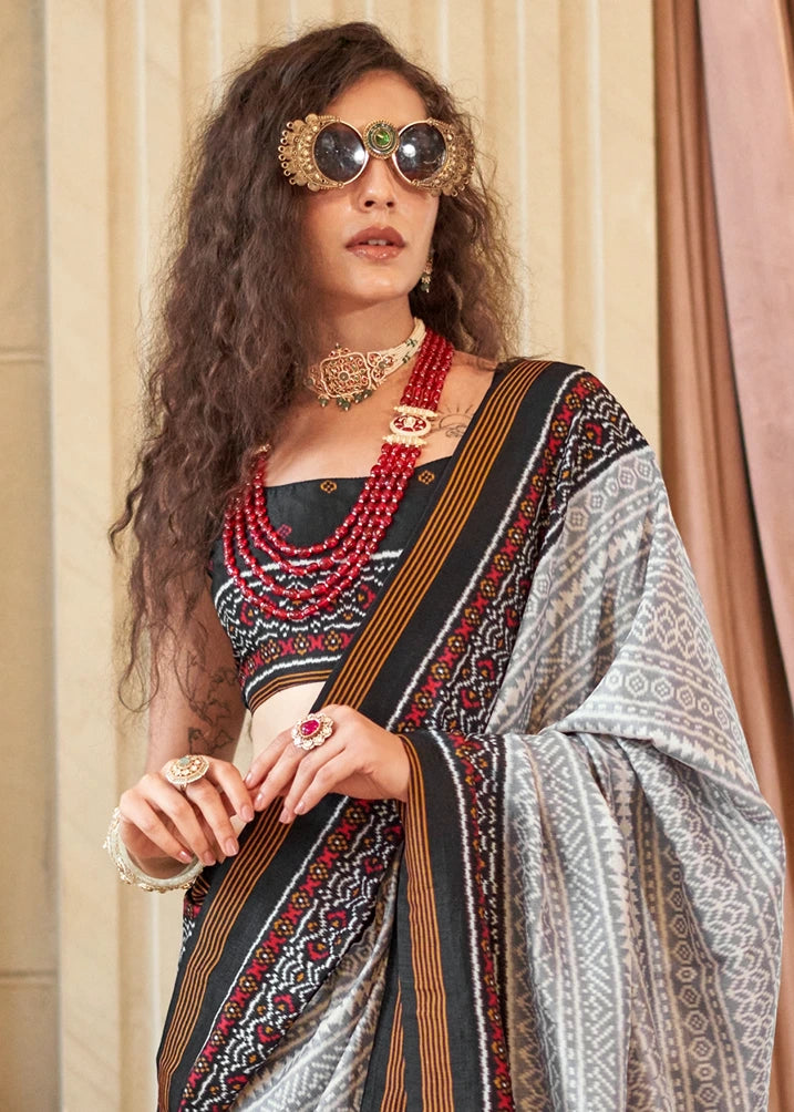 Luxury patola silk saree with smooth drape and intricate traditional motifs.