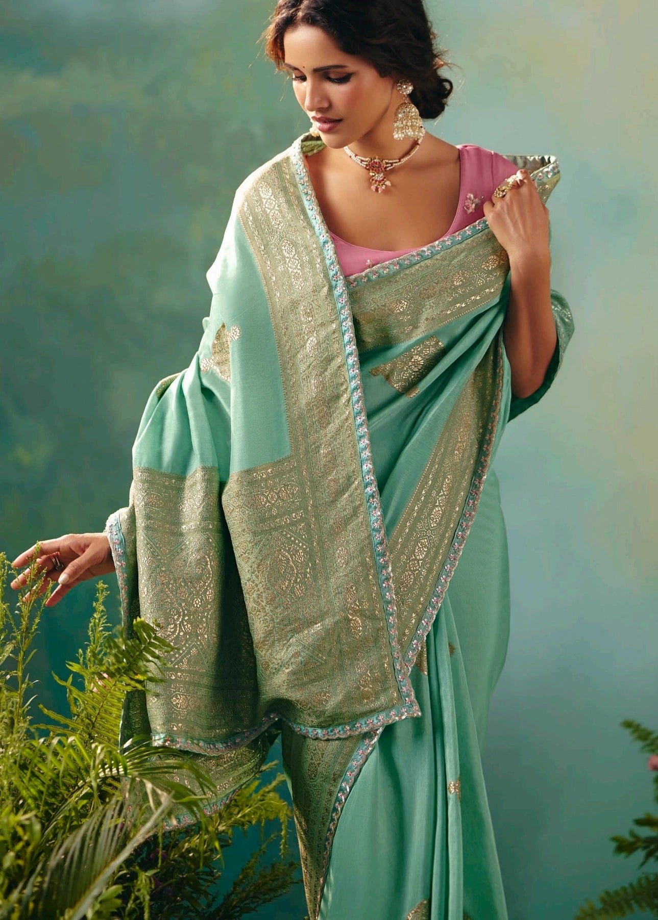 Premium sea green banarasi silk bridal saree with pastel pink embroidered blouse styled for weddings in India, USA and London UK.
