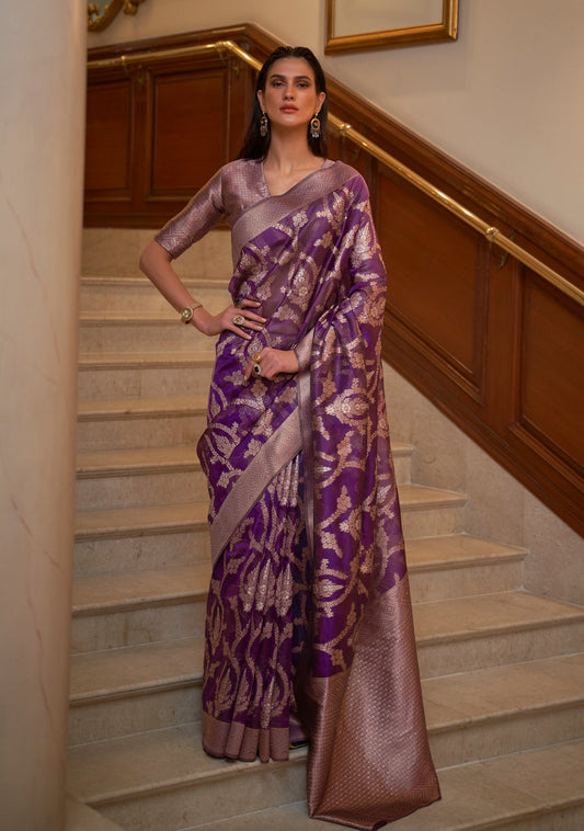 woman in Pure Banarasi Organza Zari Handloom Saree in Violet Purple colour standing on white marble stairs.