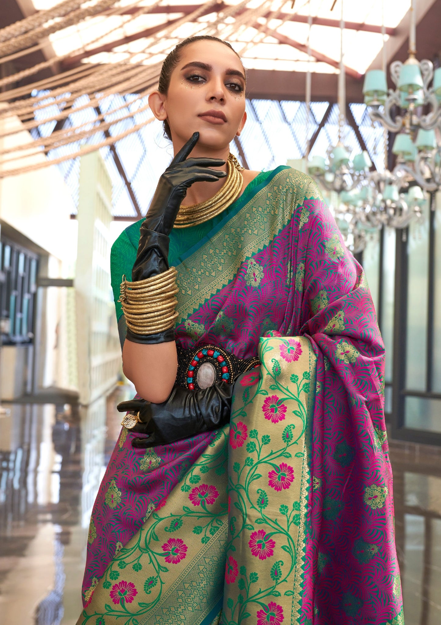 woman wearing black leather gloves and jewelery posing in Pure Banarasi Silk Handloom Bridal Saree in Magenta Pink color