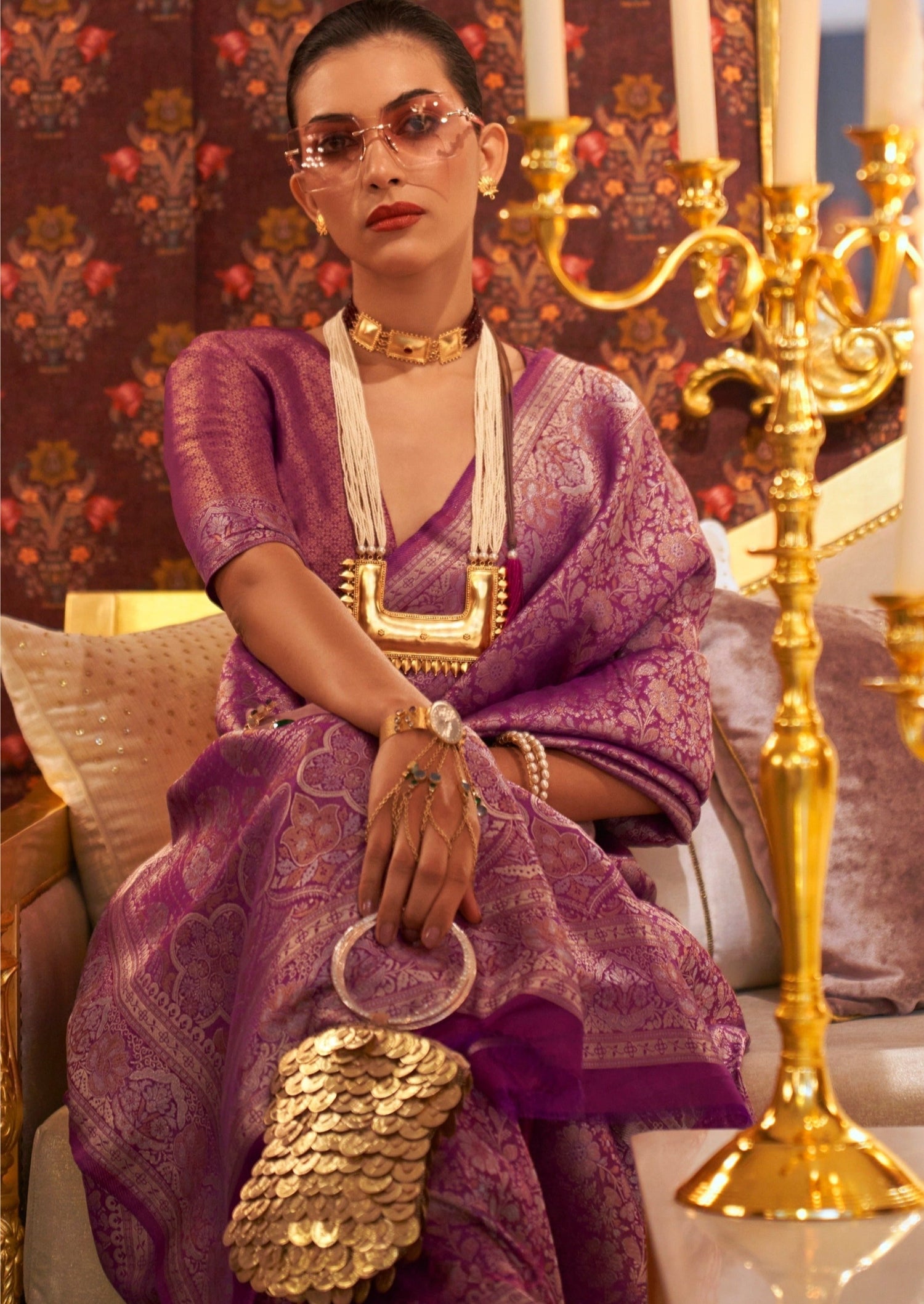 close up picture of woman sitting in Magenta pink Banarasi saree