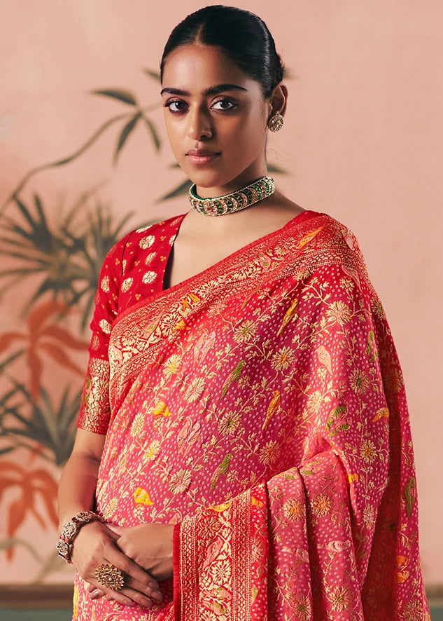 Woman wearing a rosy pastel pink bandhani saree made in pure georgette, with gold zari motifs and intricate meenakari work florals.