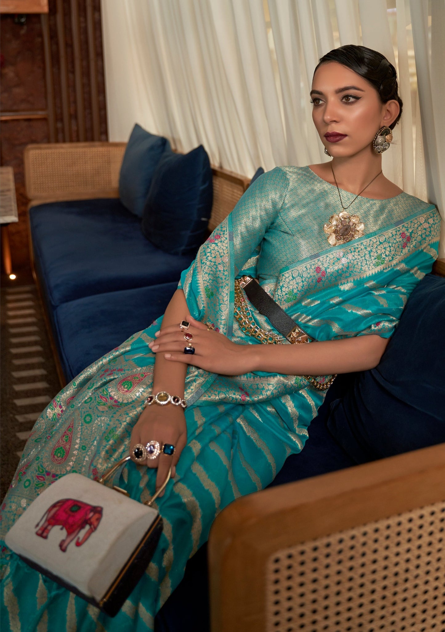 woman sitting in Pure Handloom Banarasi Organza Turquoise Blue Saree