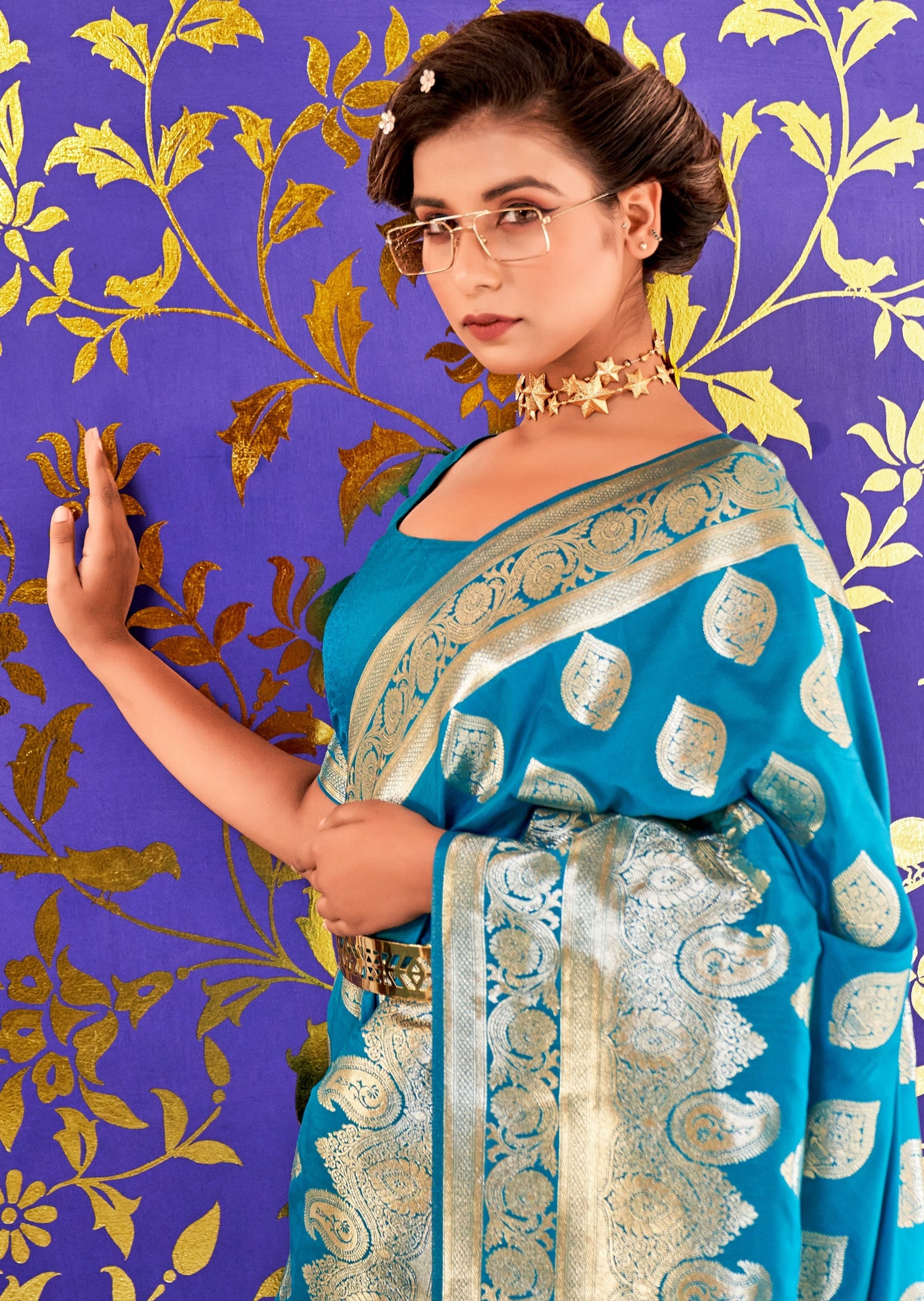 Woman in blue Banarasi Silk saree looking direct in camera