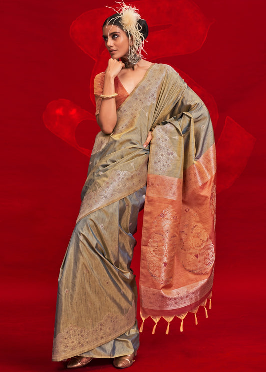 Pure handloom tussar silk grey saree with orange blouse featuring traditional indian saree design.