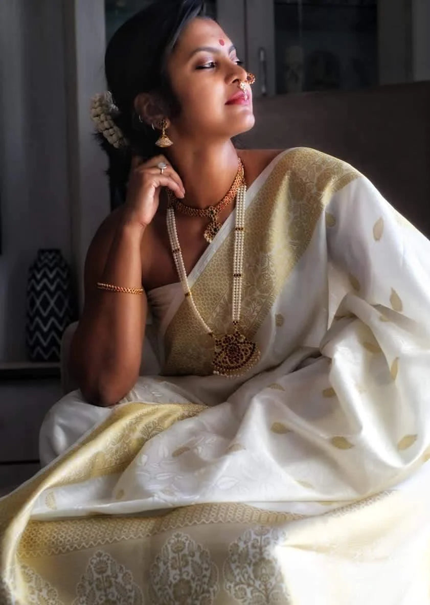 Pure kanjivaram silk white handloom wedding look saree with golden zari border online.