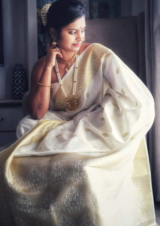 Pure kanjivaram silk white handloom saree with golden zari work border online.