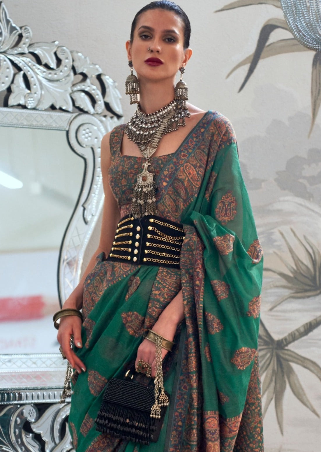 Woman in kashmiri silk green bridal saree blouse.