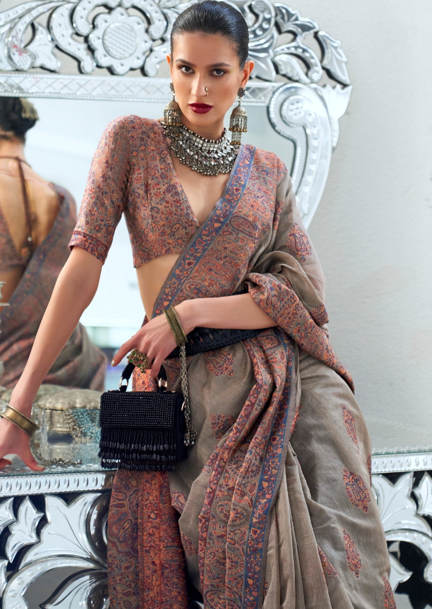 Woman in pure kashmiri silk handloom saree blouse in kani hand embroidery design.