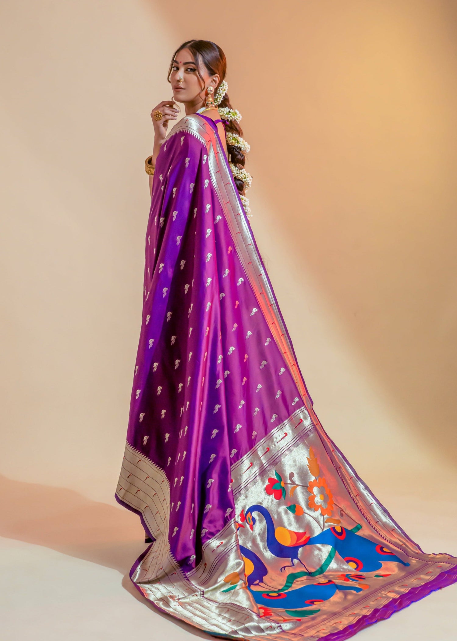 Woman in pure paithani silk magenta pink handloom bridal saree.