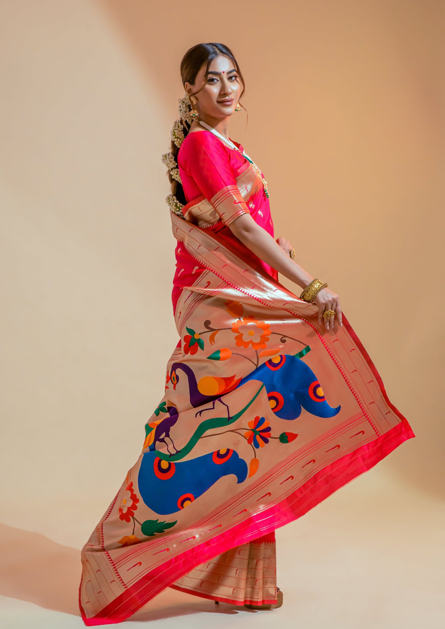 indian woman displaying Pure Paithani Silk Red Handloom Bridal Saree pallu design featuring two big peacocks