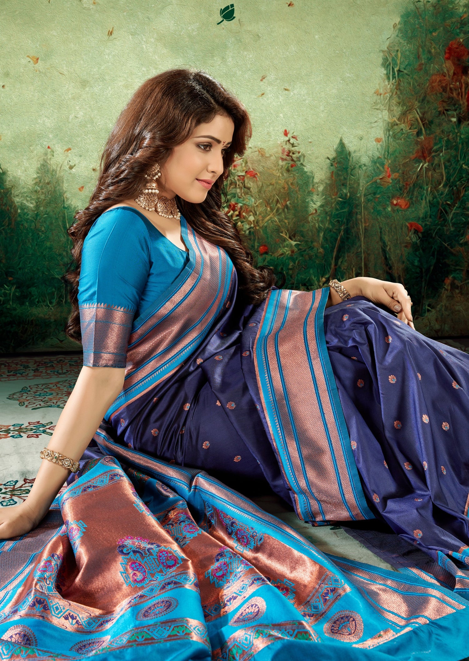 woman in copper zari peshwai saree in blue colour with contrast blouse sitting on floor