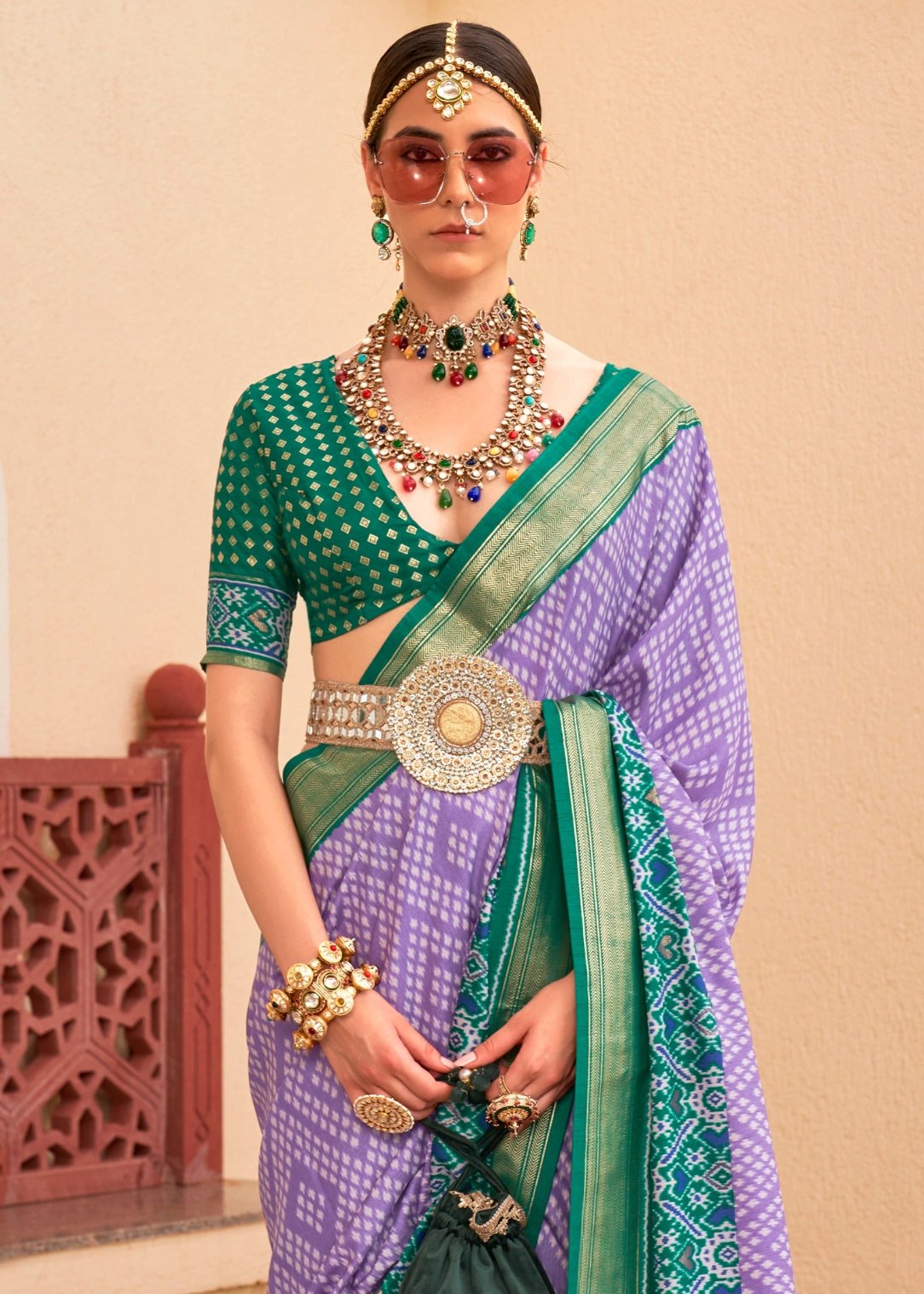 Purple patola silk saree with green blouse online for wedding function look.