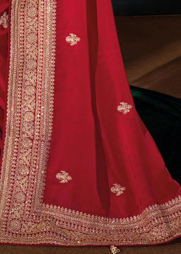 Intricate gold embroidery details on the pallu of a royal red bridal silk saree.