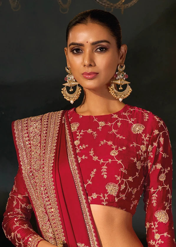 Model wearing a stitched red silk blouse with heavy gold embroidery, sequins motifs and beadwork.