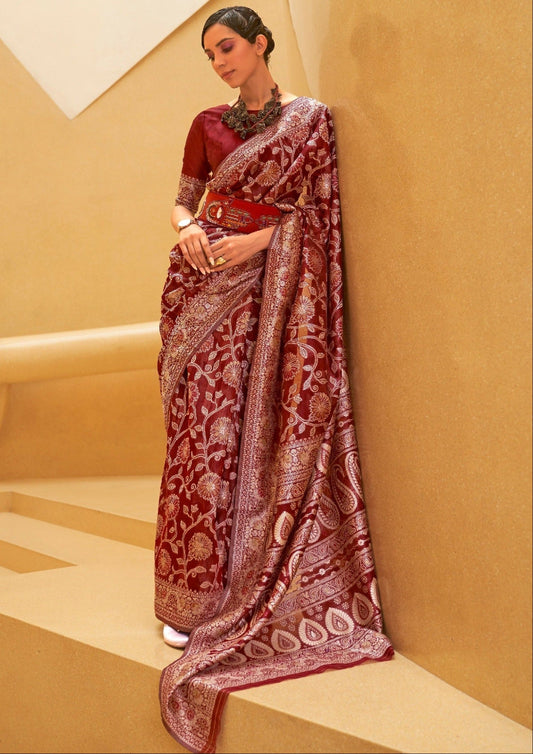 Woman standing in red lucknowi chikankari saree made in pure cotton fabric.