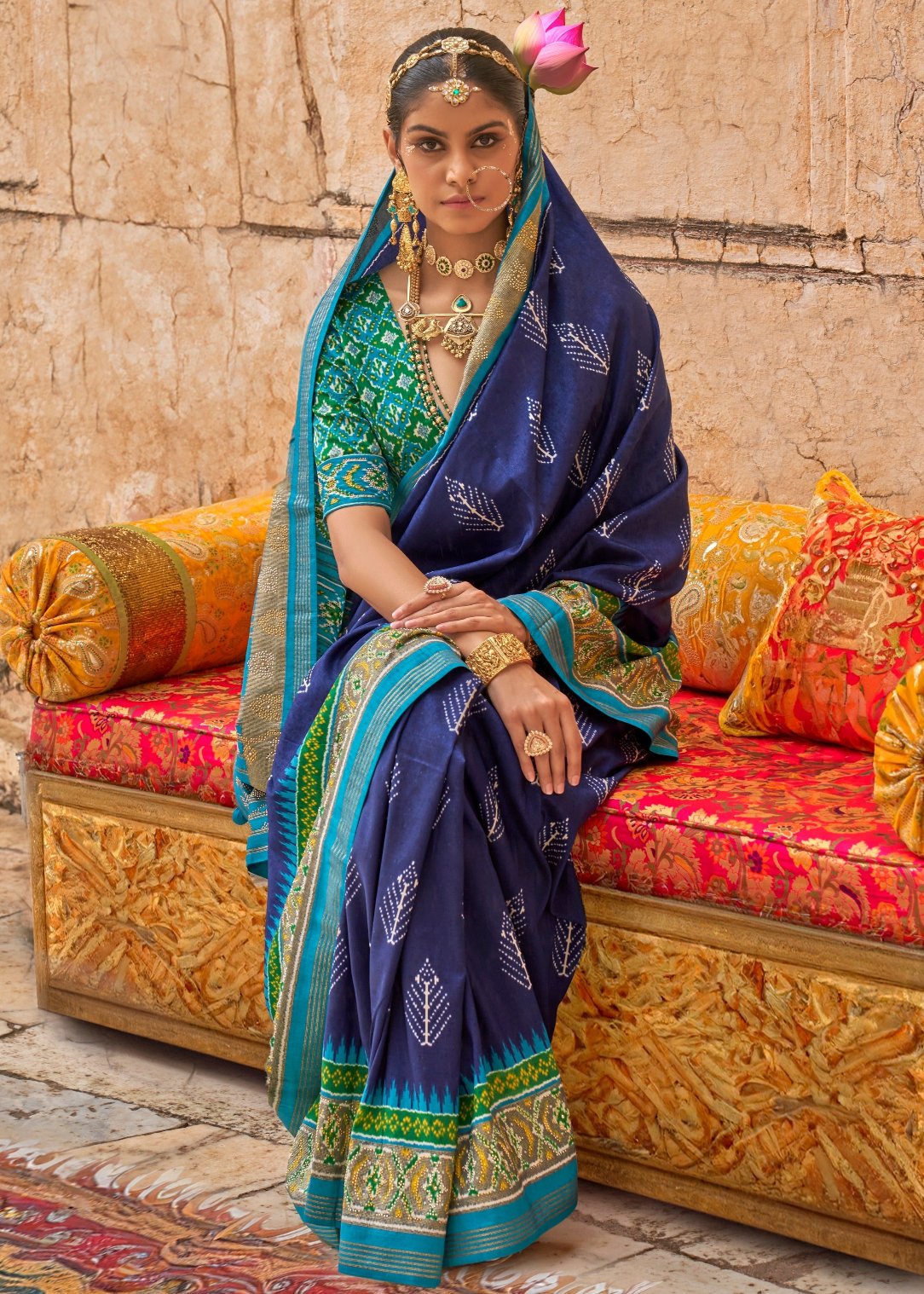 Designer patola silk royal blue bridal saree online with contrast turquoise blue and green blouse.