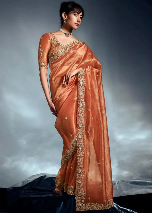 Rust orange tissue silk hand embroidered saree with intricate detailing for indian wedding wear and haldi.