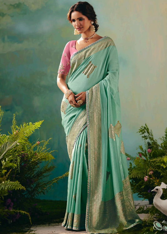 Sea green banarasi silk bridal saree with pastel pink embroidered blouse for wedding celebrations.