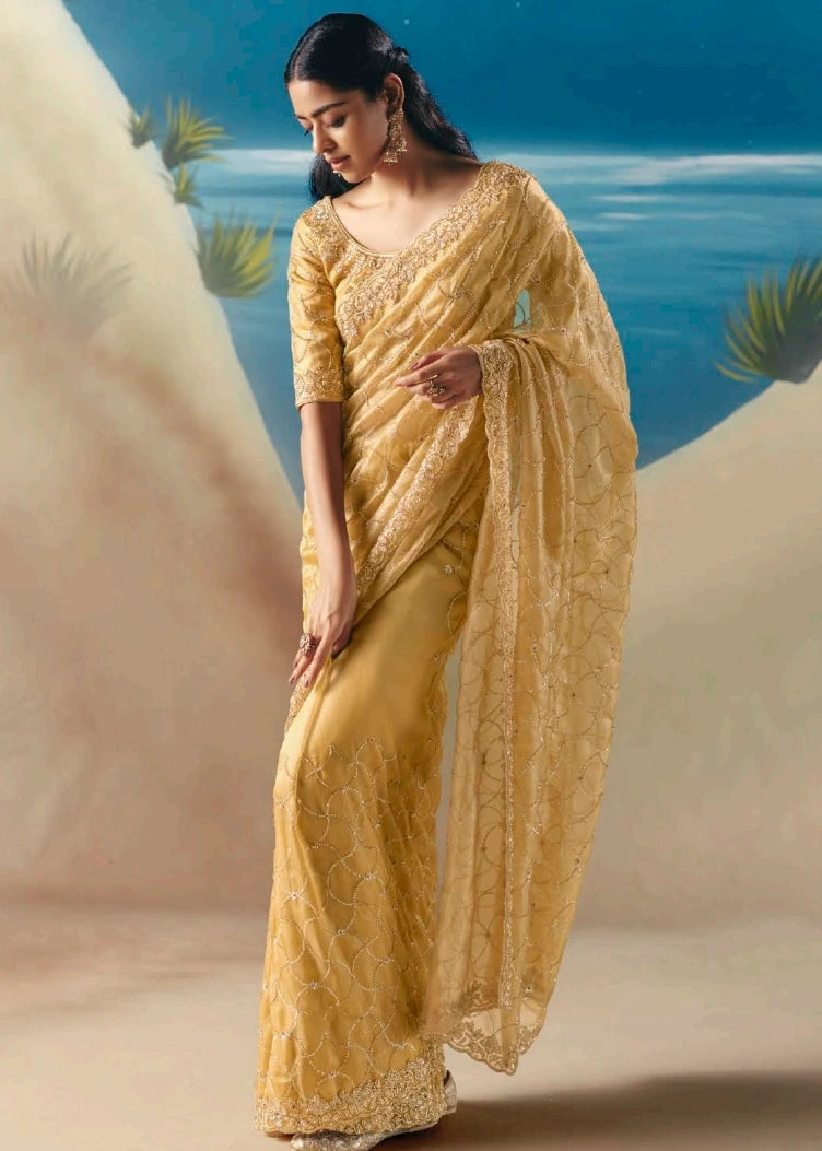Pastel yellow organza tissue silk saree with intricate beadwork and sequin hand embroidery on sheer organza tissue fabric available for online shopping.