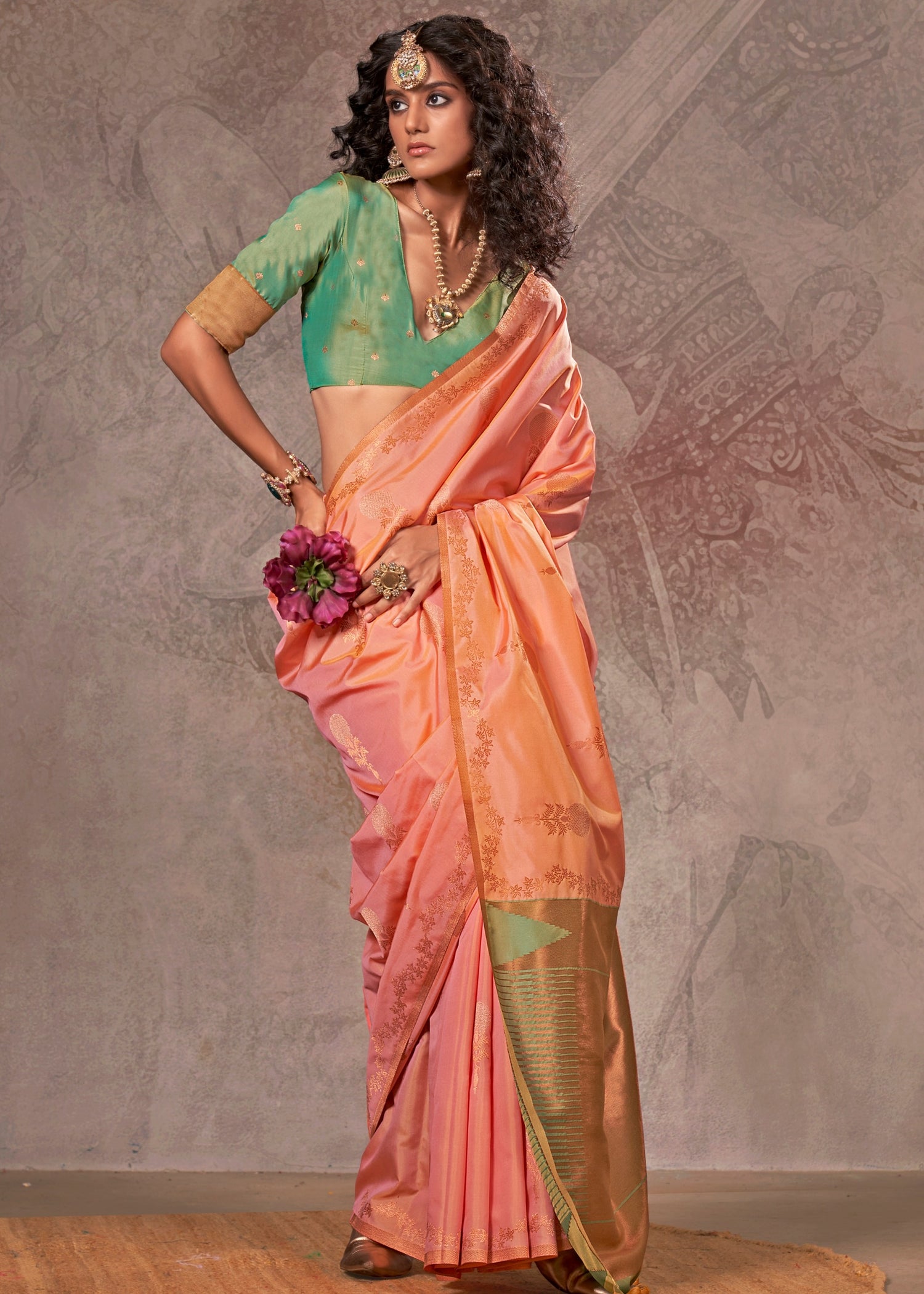 Soft handloom banarasi silk peach saree with intricate zari work and a contrast green blouse for an elegant look.