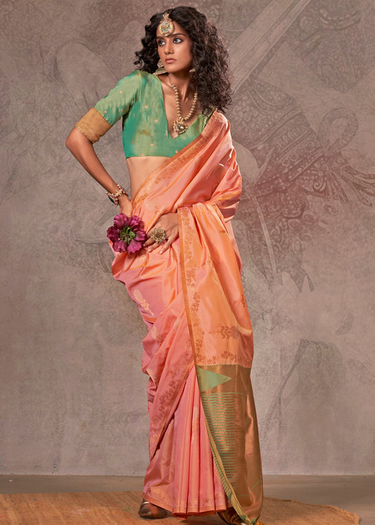 Soft handloom banarasi silk peach saree with intricate zari work and a contrast green blouse for an elegant look.