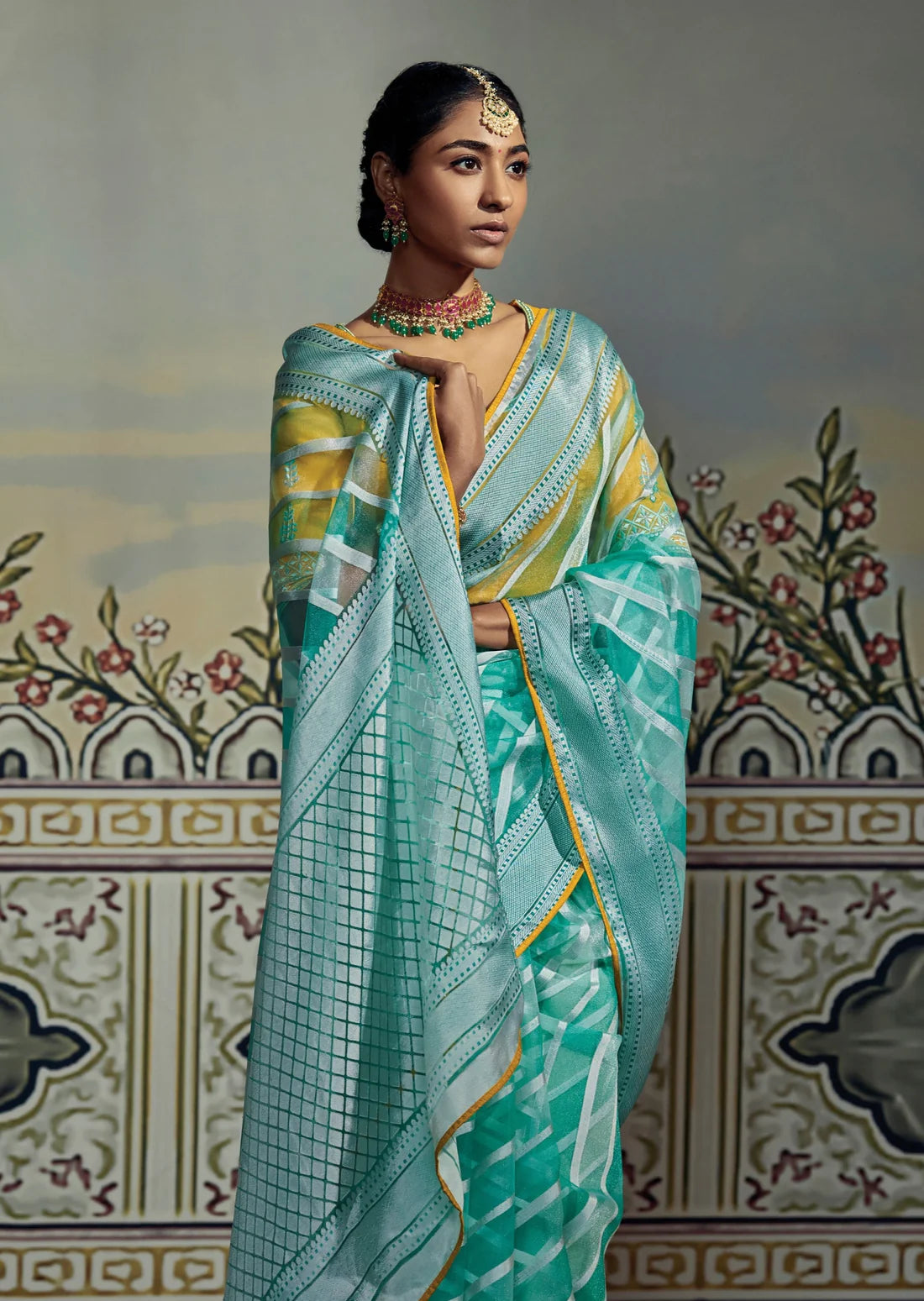 bride in soft brasso silk turquoise blue saree wearing mang tikka, necklace & earrings