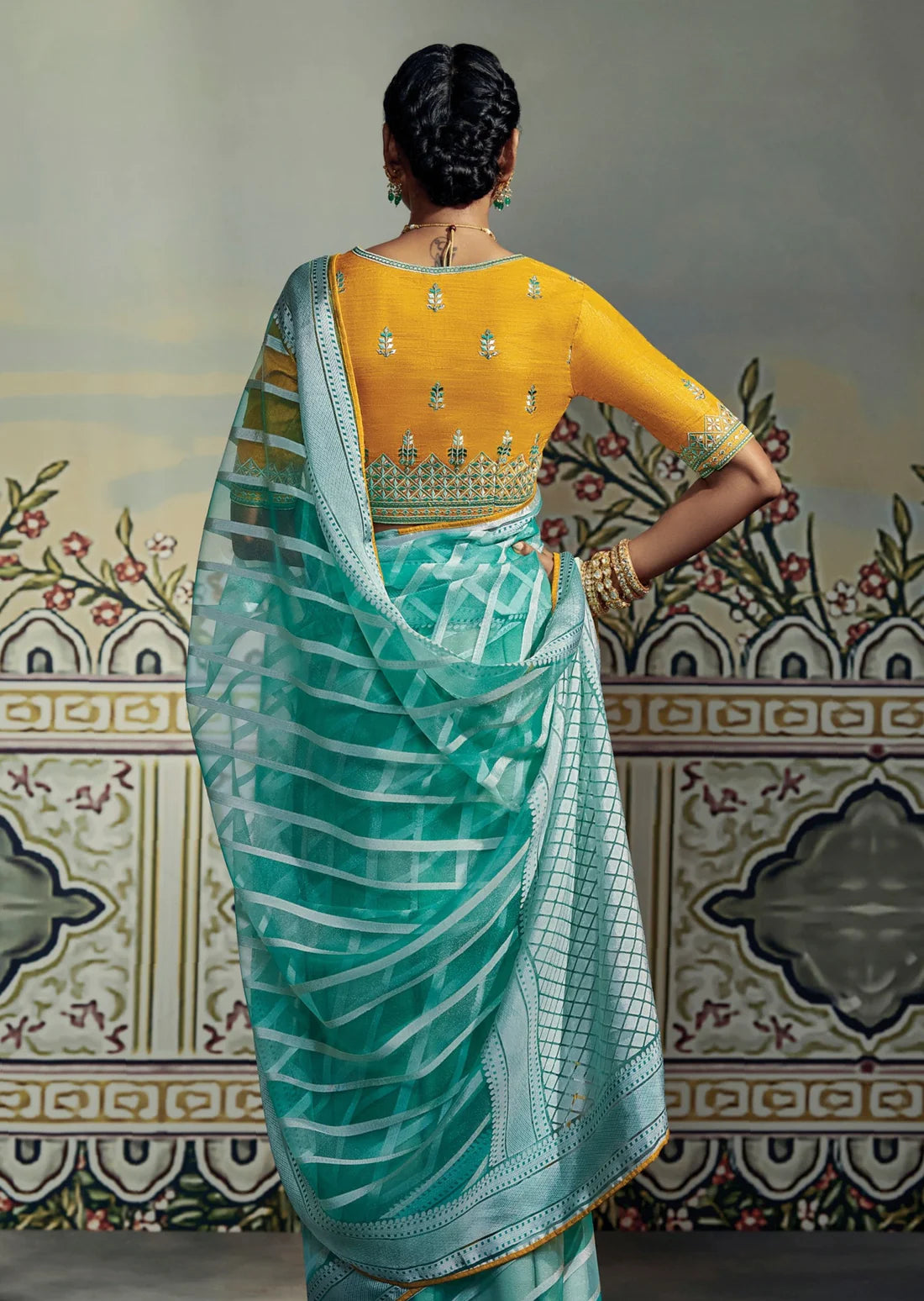 fancy soft brasso silk turquoise blue saree design with work on yellow blouse