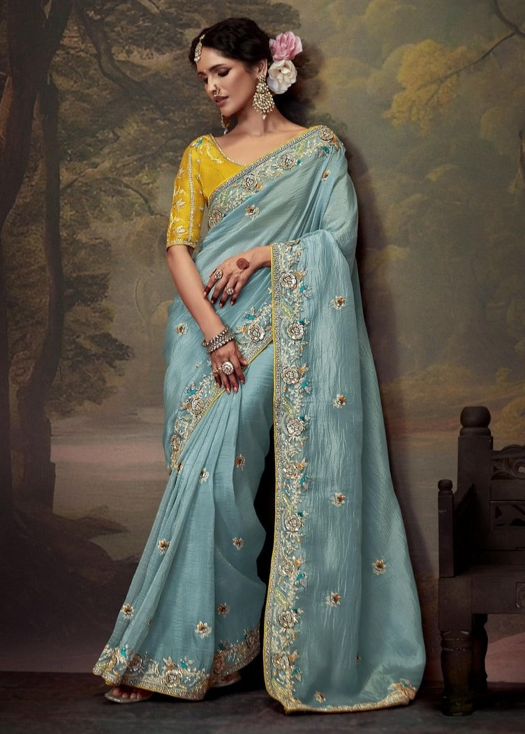 Soft crushed tissue silk saree with handwork embroidery in sky blue colour with yellow blouse.