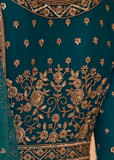 Close-up of a teal blue embroidered anarkali featuring intricate gold floral sequins embroidery and metallic beadwork.