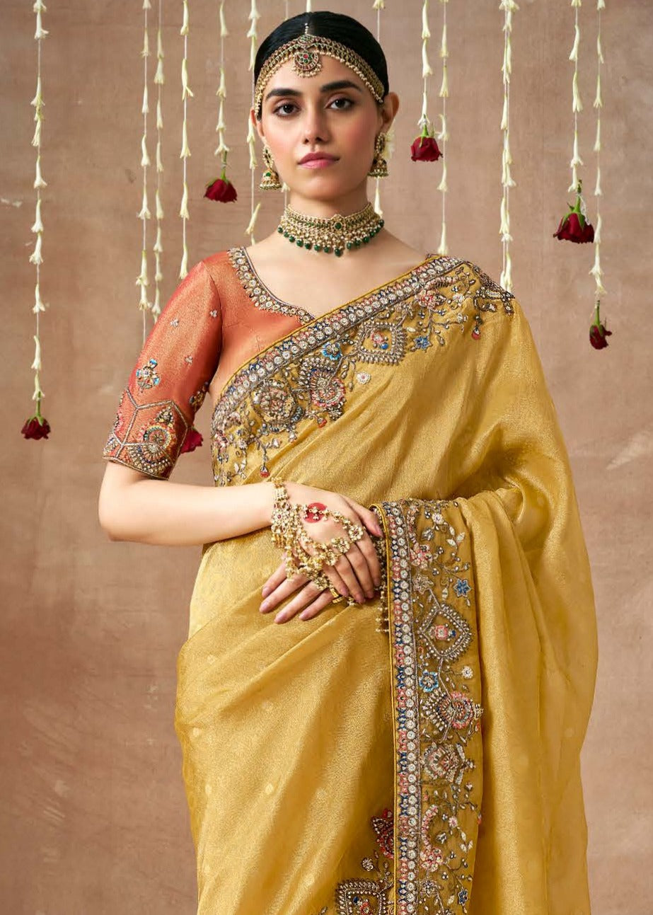 Shop pure tissue silk hand embroidery work saree uk online for indian women in yellow orange color.