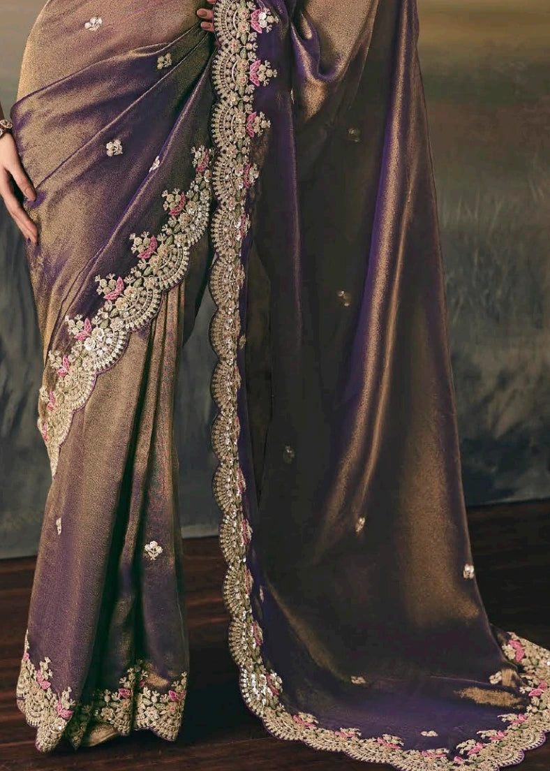 Close-up of pallu of metallic copper brown tissue silk bridal saree with intricate hand embroidery and zari detailing. 