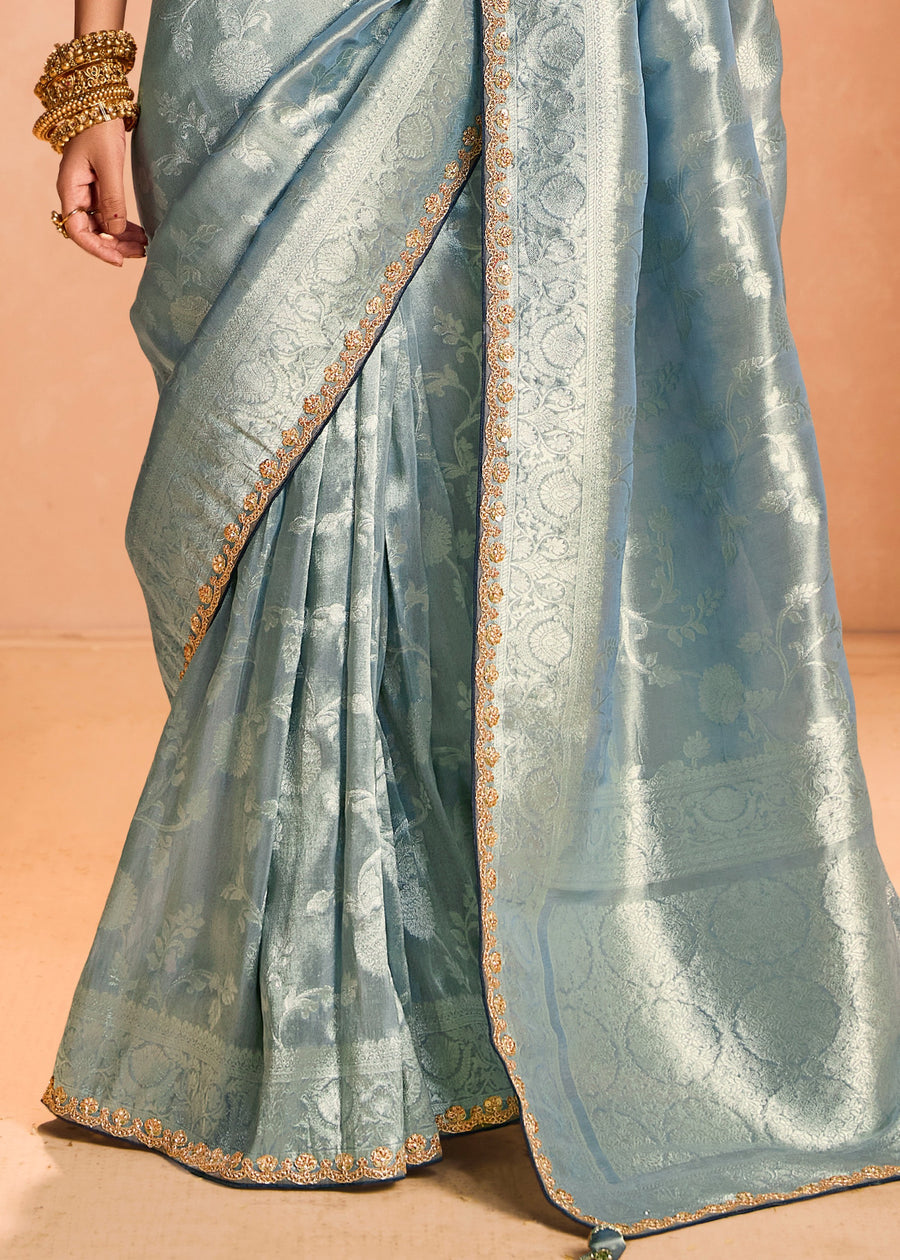 Luxurious pure banarasi tissue silk saree in pastel blue with delicate embroidery and gold zari weaving.