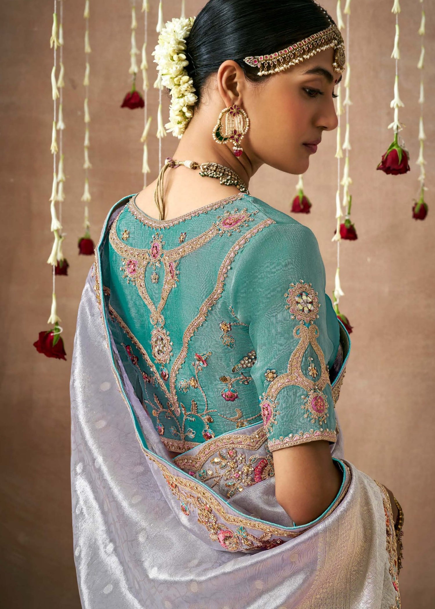 Banarasi tissue silk embroidery work silver saree online with contrast aqua blue blouse.