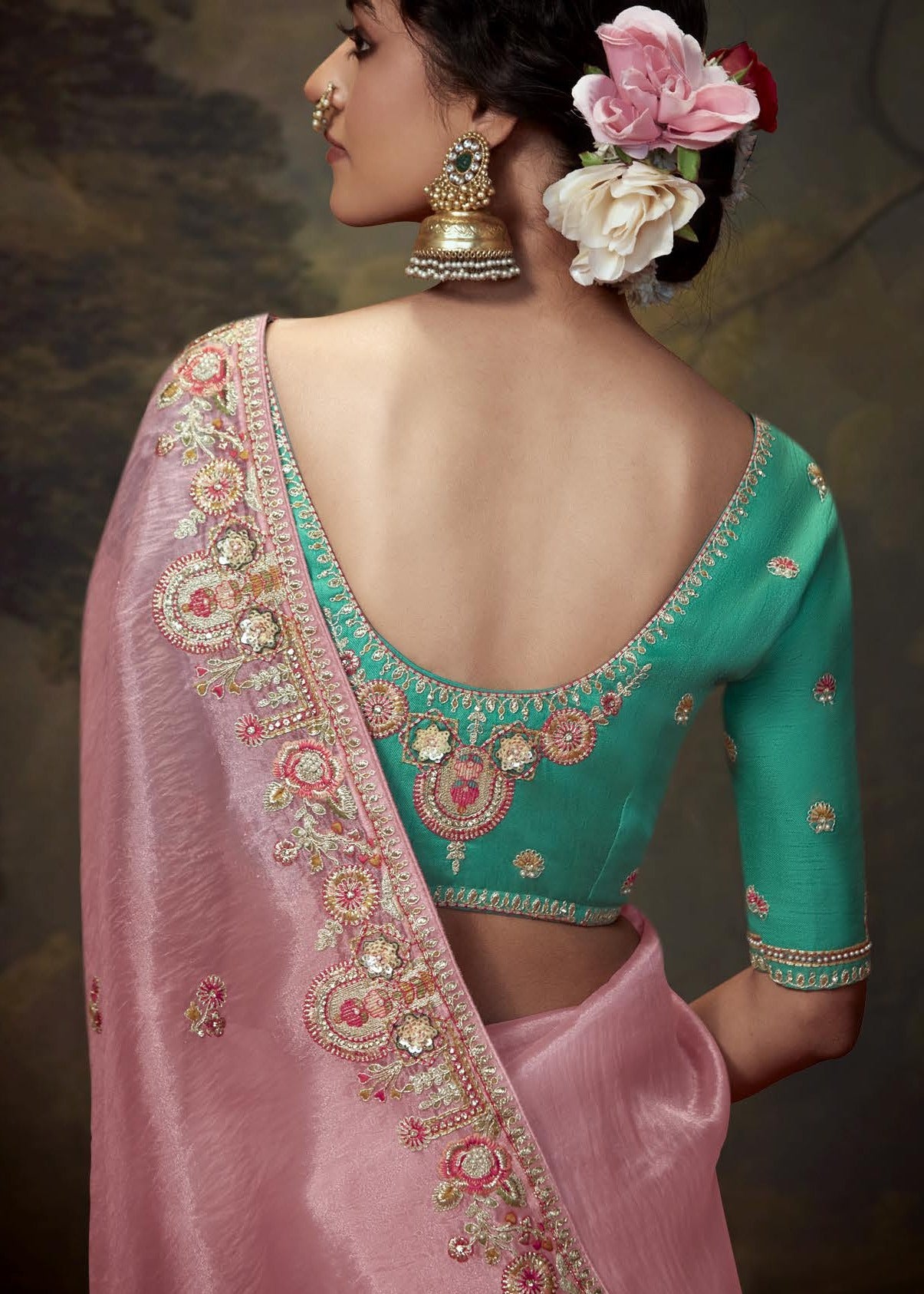 Luxurious rose pink saree with crushed tissue silk fabric and green embroidered blouse piece, perfect for USA wedding celebrations.