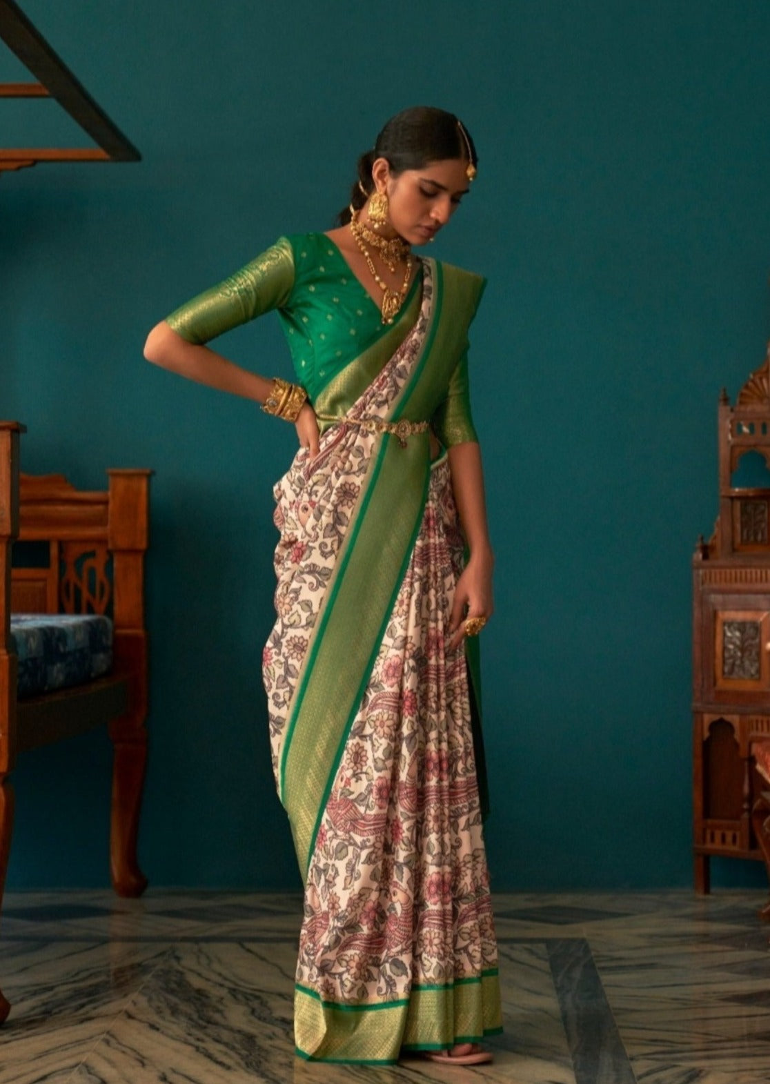 Woman standing in white and green saree