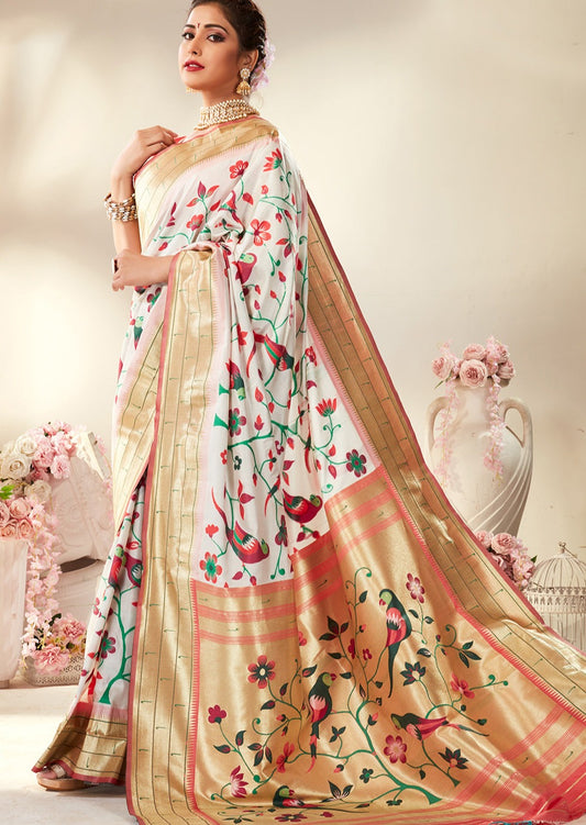 Woman in white colour paithani silk saree with pink contrast blouse having triple muniya border.