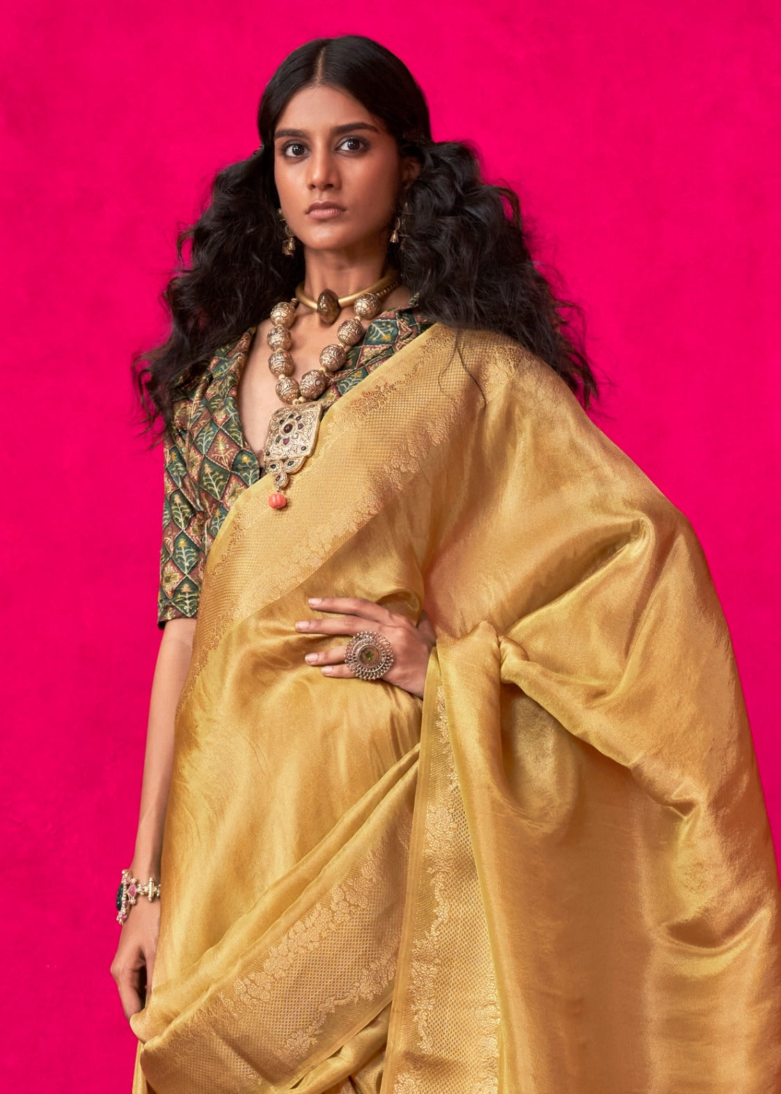 Close-up of golden yellow banarasi tissue silk saree highlighting banarasi weaving and zari work design.