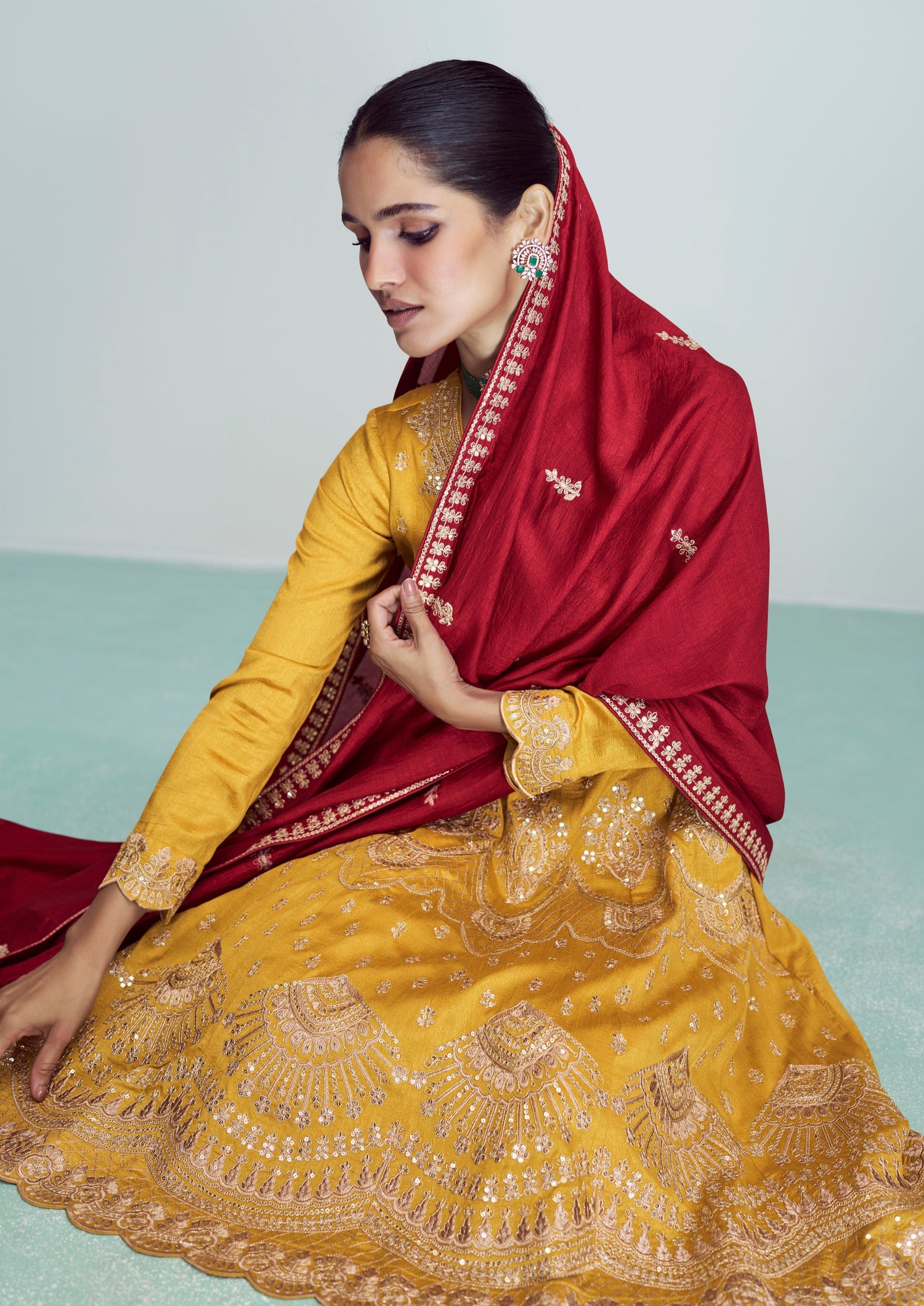 woman sitting in yellow suit with red dupatta