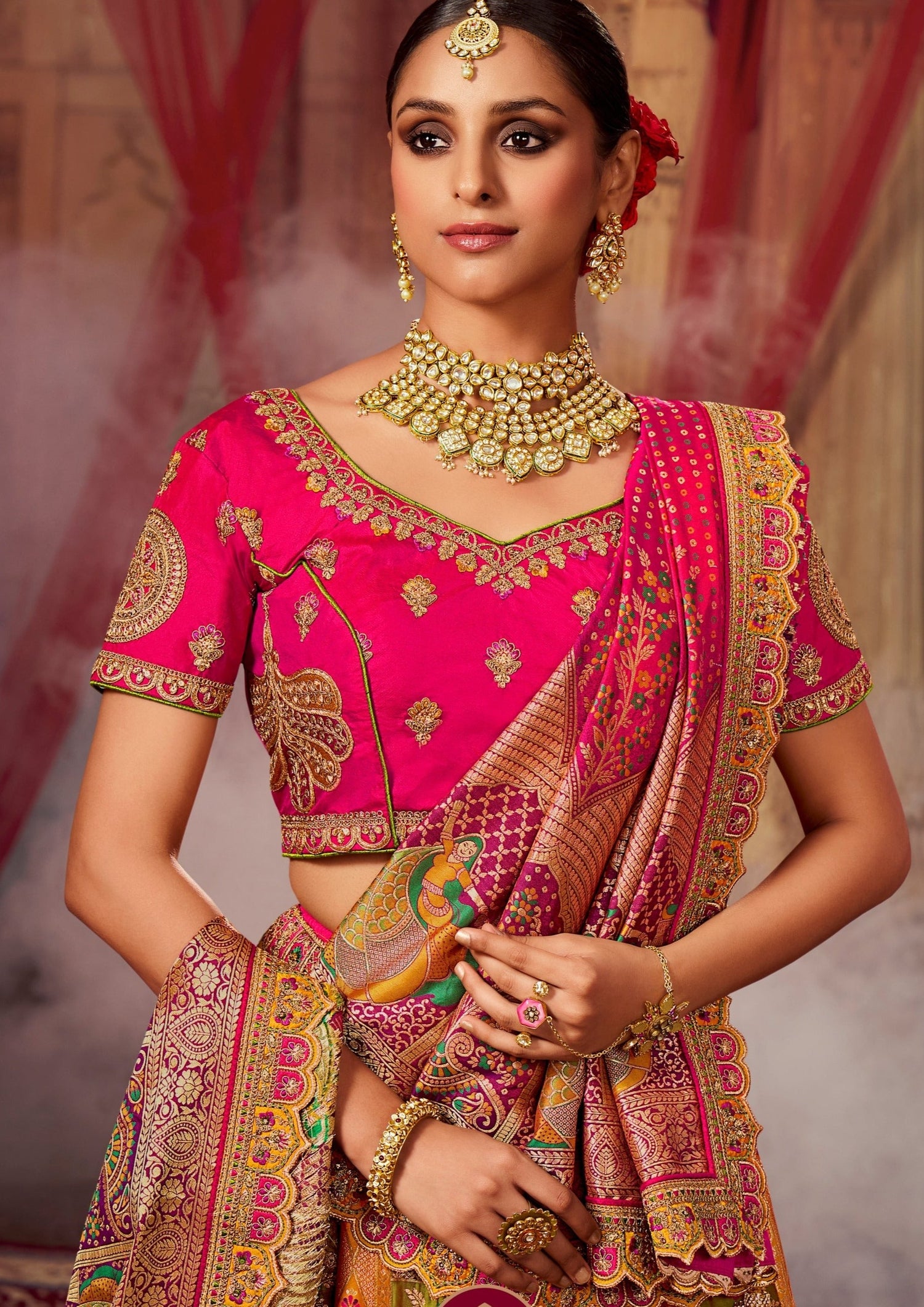 Bride in pink embroidered banarasi silk choli blouse and dupatta.