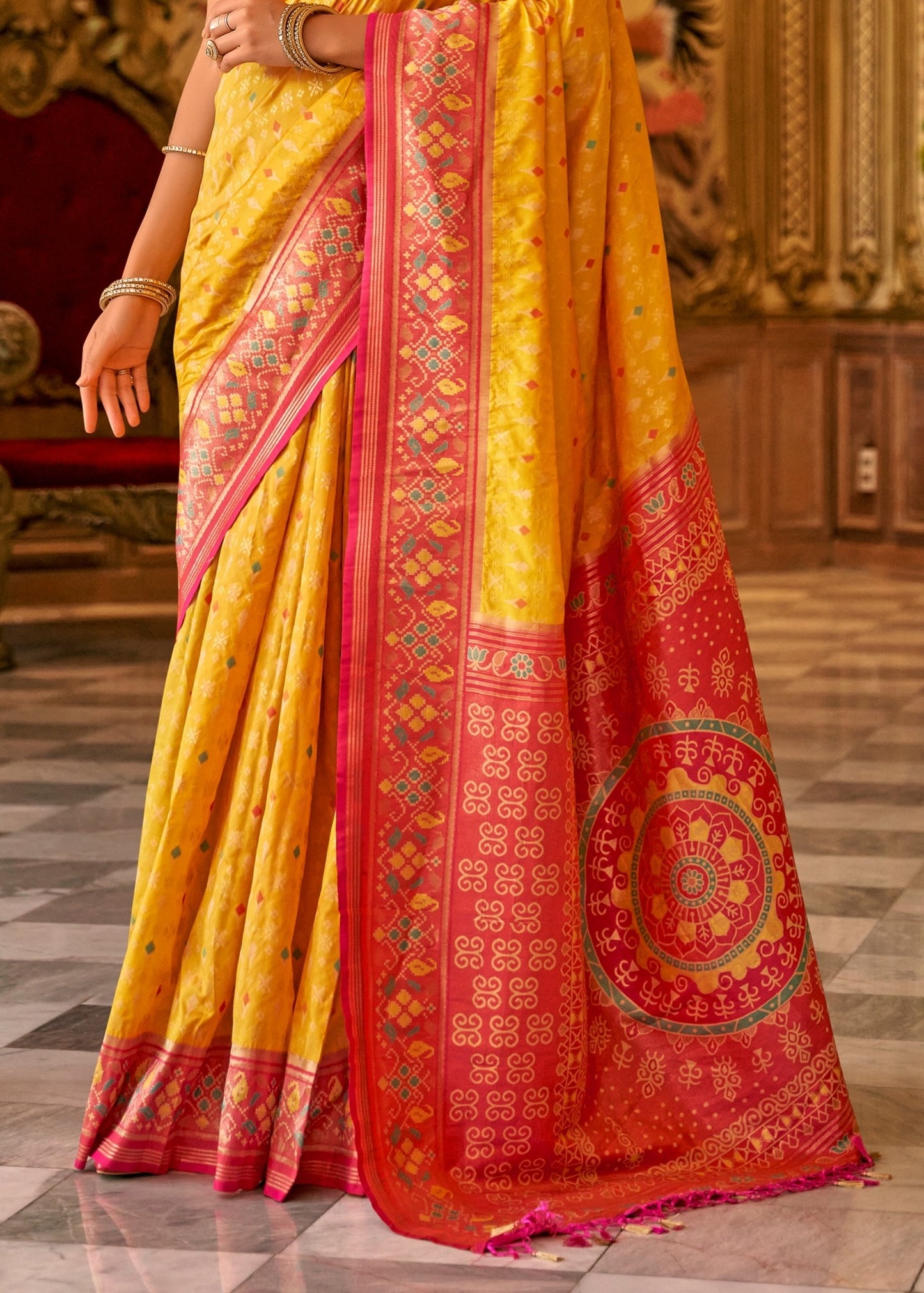 Shop yellow patola silk handloom saree with contrast red blouse online in usa with zari weaving.