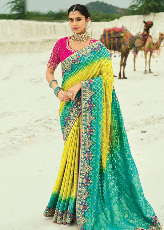 Yellow and turquoise blue ombre khaddi georgette bandhani saree with embroidery for haldi and mehendi functions.