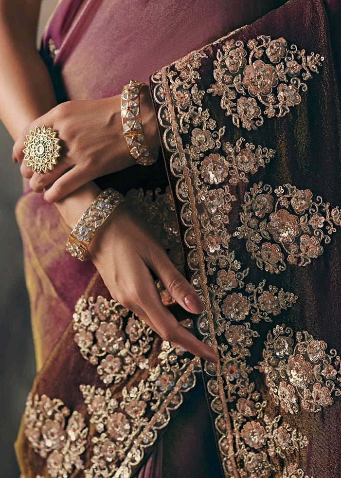 Close-up of hand embroidery and zari work on brown & pink ombre effect tissue silk embroidered bridal saree.