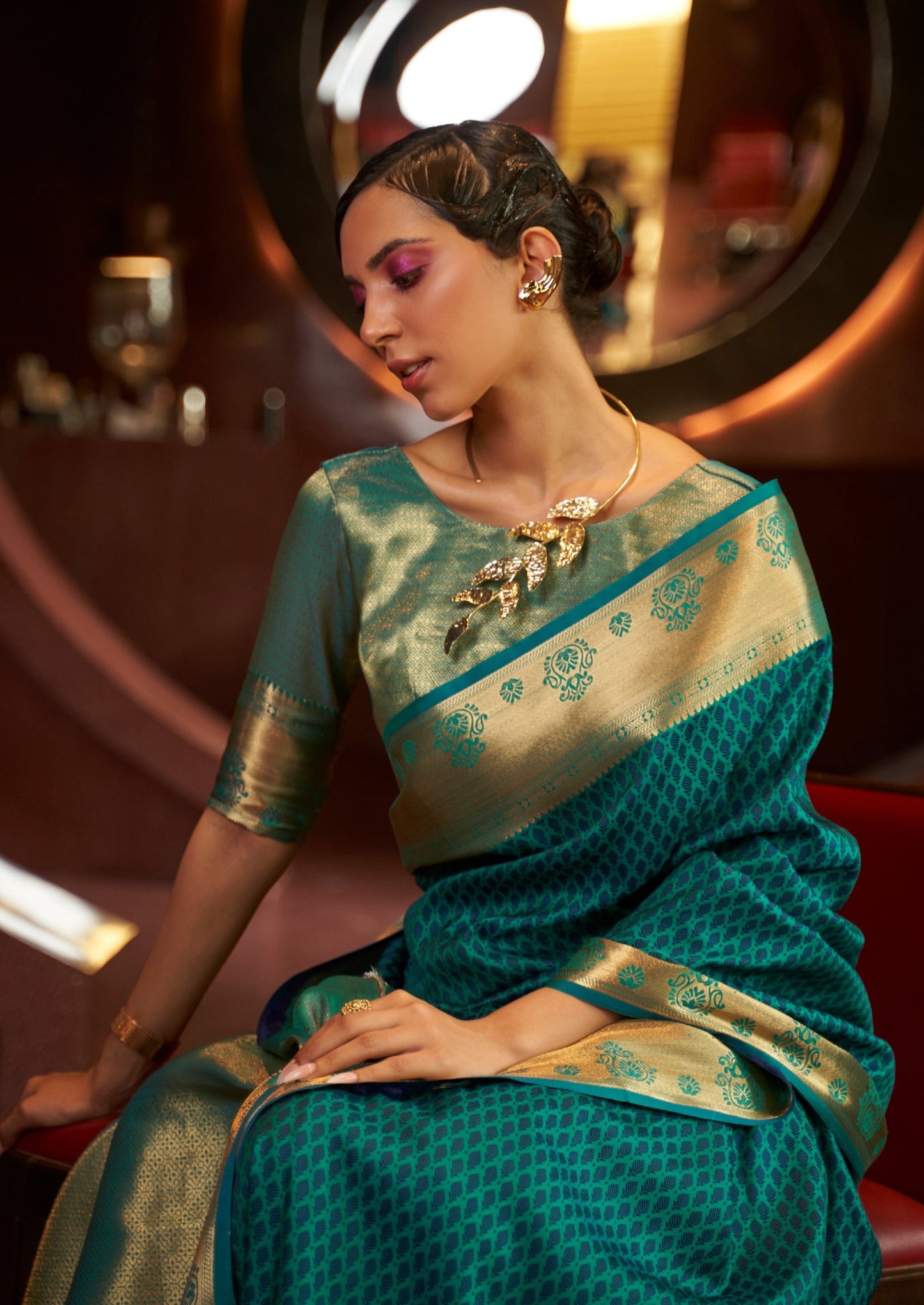 woman sitting in blue color Silk Weaving Handloom saree