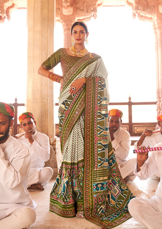 woman standing in white leheriya saree with green blouse