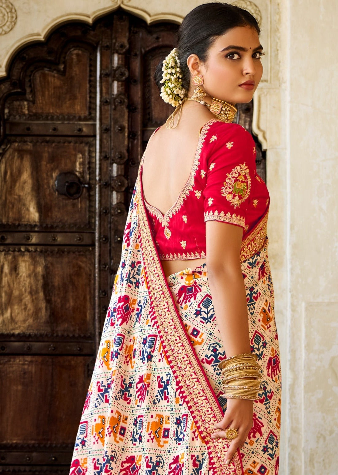 whte patola saree with red blouse